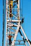 Mining Photo Stock Library - oil and gas rig worker climbing up the derrick with safety harness on.  derrick hook in the background. ( Weight: 1  New Image: NO)